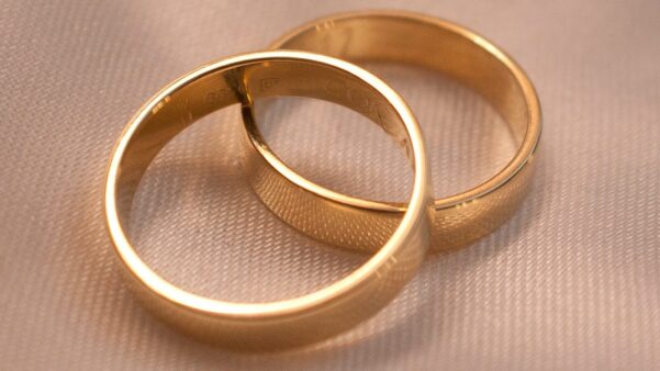 gold ring on white textile